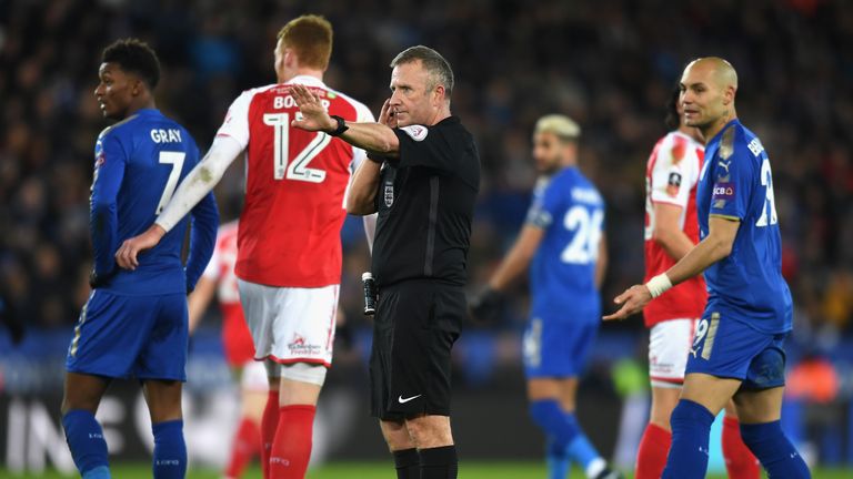 Referee Jon Moss calls for video assistance prior to awarding Leicester's second goal