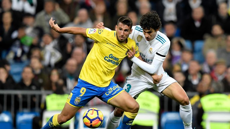 Las Palmas forward Jonathan Calleri (L) challenges Real Madrid defender Jesus Vallejo