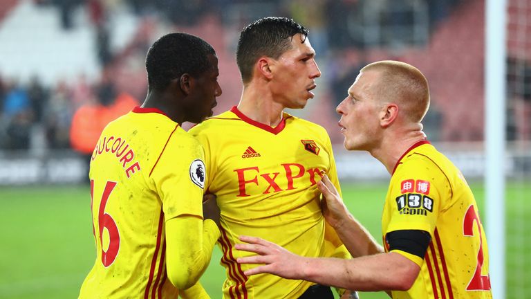 Jose Holebas of Watford is restrained by team-mates at the end of the match after arguing with Watford supporters 