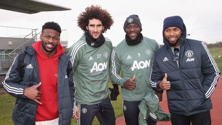 Marouane Fellaini and Romelu Lukaku pose alongside NFL stars Josh Norman and Emmanuel Sanders at Manchester United's Aon Training Complex
