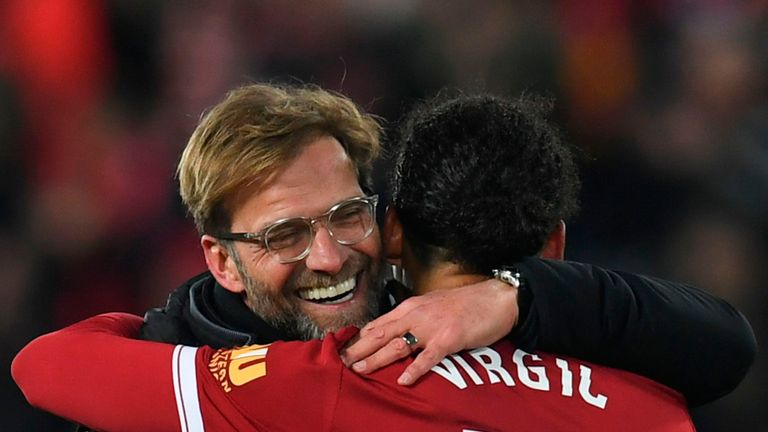 Liverpool's German manager Jurgen Klopp (L) hugs Liverpool's Dutch defender Virgil van Dijk (R) at the end of the English FA Cup third round football match