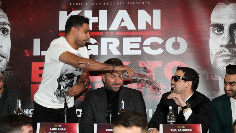 Amir Khan throws a glass of water over Phil Lo Greco