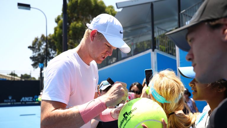 Kyle Edmund of Great Britain signs autographs for fans after completing a practice session on day 10 of the 2018 Australian Open