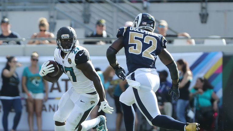 JACKSONVILLE, FL - OCTOBER 15:   Leonard Fournette #27 of the Jacksonville Jaguars runs with the football in front of Alec Ogletree #52 of the Los Angeles 