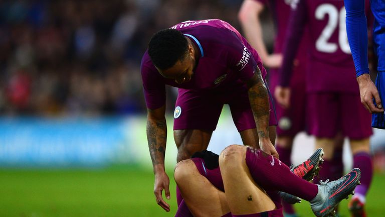Leroy Sane of Manchester City lies injured as Raheem Sterling for Manchester City
