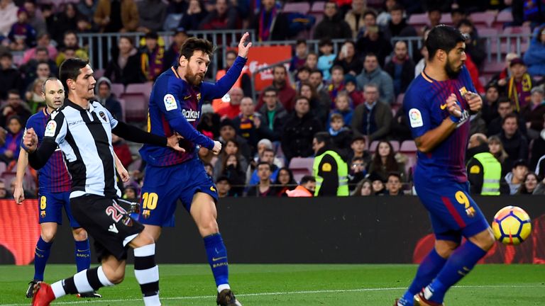 Barcelona's Lionel Messi (3L) shoots to score a goal during the Spanish league football match FC Barcelona vs Levante UD