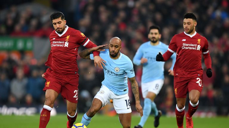 LIVERPOOL, ENGLAND - JANUARY 14:  Emre Can of Liverpool and Fabian Delph of Manchester City clash as Alex Oxlade-Chamberlain of Liverpool looks on during t