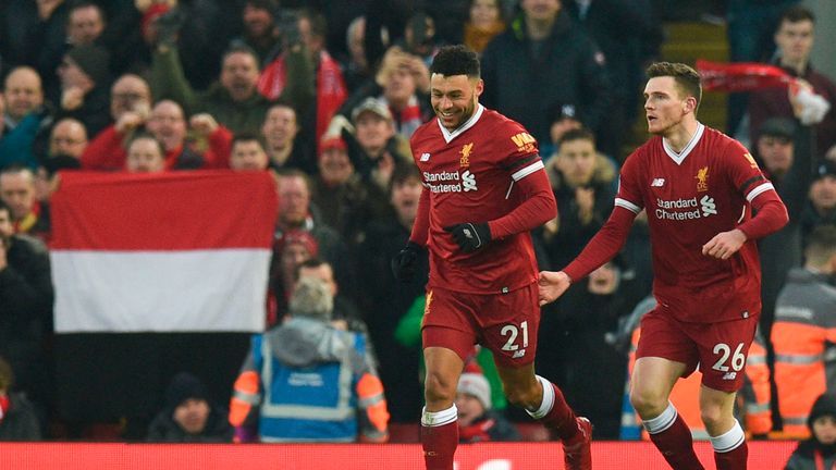 Liverpool's English midfielder Alex Oxlade-Chamberlain (C) celebrates scoring the opening goal during the English Premier League football match between Liv
