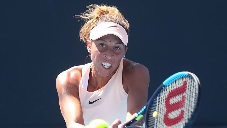 Madison Keys of the United States plays a backhand in her first round match against Qiang Wang of China