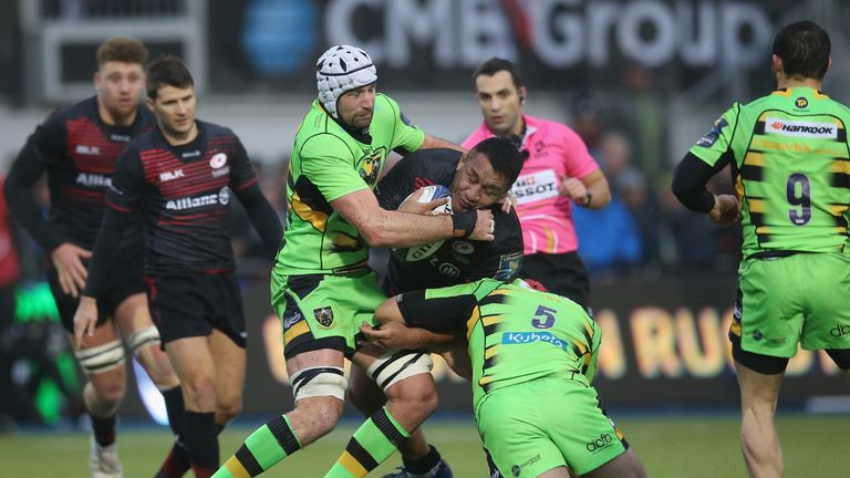 Mako Vunipola of Saracens is tackled by Michael Paterson and Christian Day of Northampton Saints 