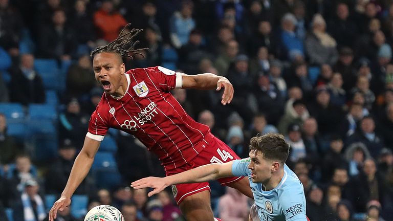 Manchester City's John Stones brings down Bristol City's Bobby Reid inside the box, resulting in a penalty, during the Carabao Cup Semi Final, First Leg