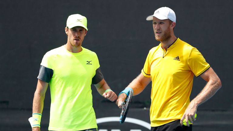 MELBOURNE, AUSTRALIA - JANUARY 20:  Marcus Daniell of New Zealand (L) and Dominic Inglot of Great Britain talk tactics in their second round men's doubles 