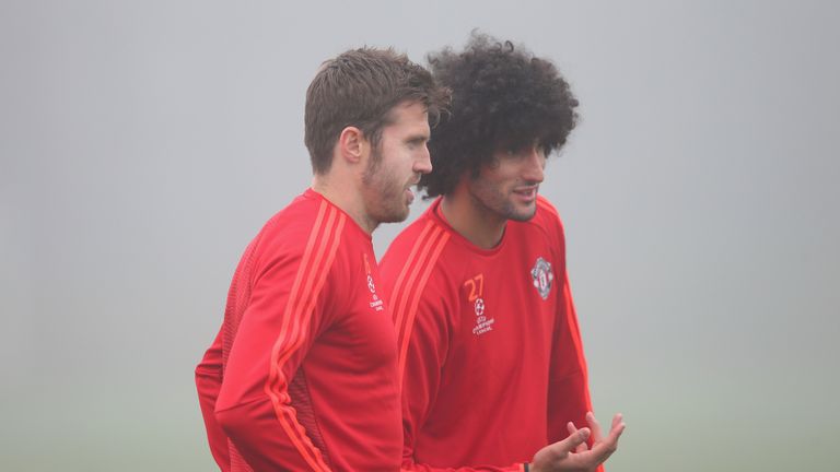 MANCHESTER, ENGLAND - NOVEMBER 02:  Marouane Fellaini and Michael Carrick of Manchester United talk during a Manchester United training session on the eve 