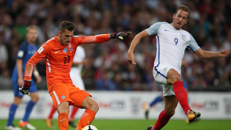 Slovakia's Martin Dubravka (left) kicks under pressure from England's Harry Kane during the 2018 FIFA World Cup Qualifying, Group F match at Wembley Stadiu