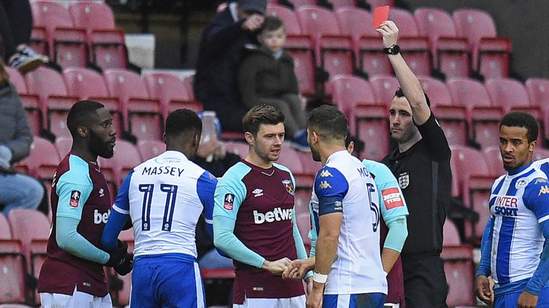 Arthur Masuaku is shown a red card by referee Chris Kavanagh