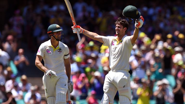 Australia's Mitchell Marsh (R) celebrates scoring his century against England with his teammate and brother Shaun Marsh (L) on the fourth day of the fifth 