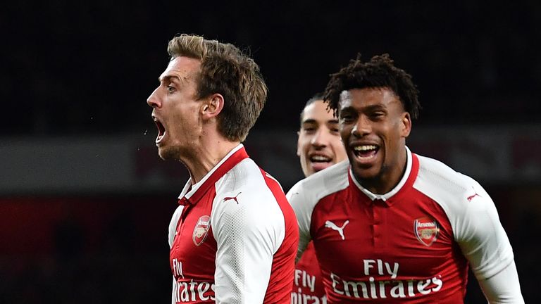 Arsenal's Spanish defender Nacho Monreal (L) celebrates scoring the team's first goal during the League Cup semi-final football match between Arsenal and C
