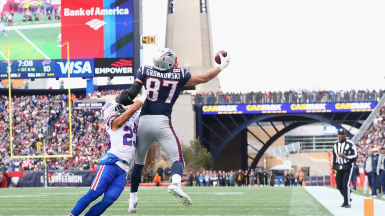 FOXBORO, MA - DECEMBER 24:  Rob Gronkowski #87 of the New England Patriots catches a touchdown pass as he is defended by Micah Hyde #23 of the Buffalo Bill