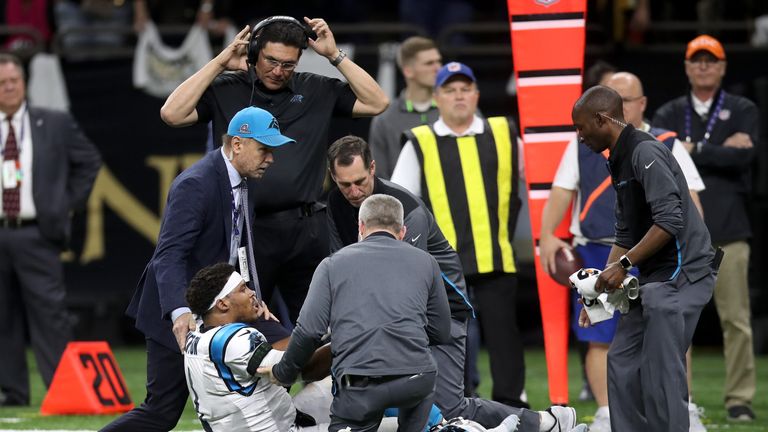 Cam Newton is checked by Panthers medical staff