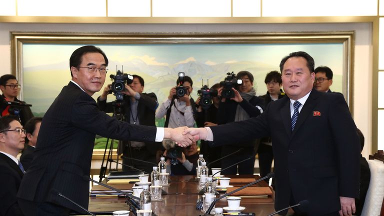 South Korean Unification Minister Cho Myoung-gyon (L) shakes hands with the head of North Korean delegation Ri Son-Gwo