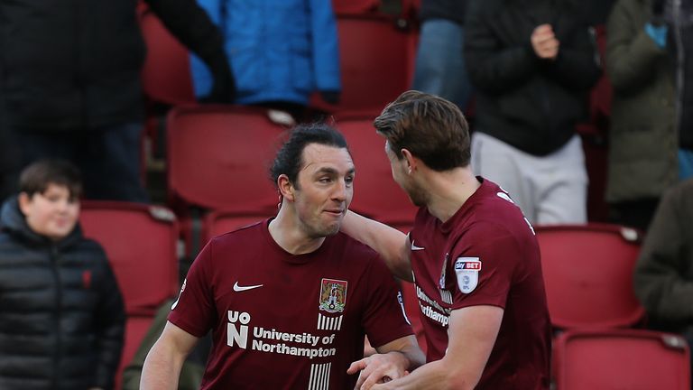 NORTHAMPTON, ENGLAND - JANUARY 06: John-Joe O'Toole of Northampton Town celebrates with team mate Ash Taylor after scoring his sides first goal during the 
