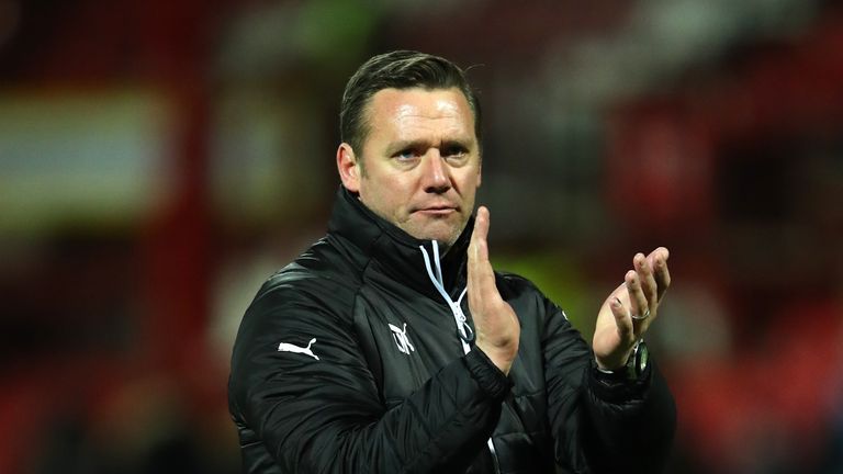 Kevin Nolan applauds the travelling supporters at Griffin Park