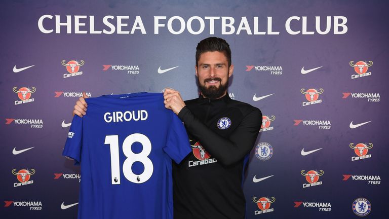 Olivier Giroud poses with a Chelsea shirt after signing for the club on January 31, 2018