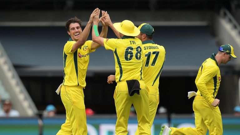 Patrick Cummins of Australia celebrates with his team mates after taking a wicket during game four of the One Day International