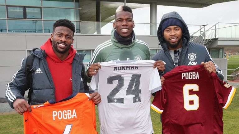 Paul Pogba poses alongside NFL stars Josh Norman and Emmanuel Sanders at Manchester United's Aon Training Complex