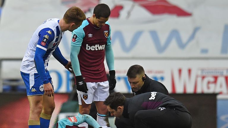 West Ham United's Spanish midfielder Pedro Obiang receives medical attention after picking up an injury during the English FA Cup fourth round football mat