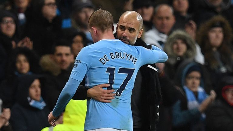 Manchester City's Spanish manager Pep Guardiola (R) embraces Manchester City's Belgian midfielder Kevin De Bruyne as he is substituted during the English P