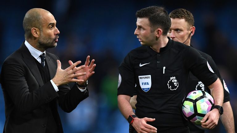 Manchester City's Spanish manager Pep Guardiola (L) speaks with referee Michael Oliver after the English Premier League football match between Manchester C