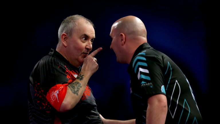 Phil Taylor with Rob Cross after a missed chance for a nine-darter in the World Darts Championship final