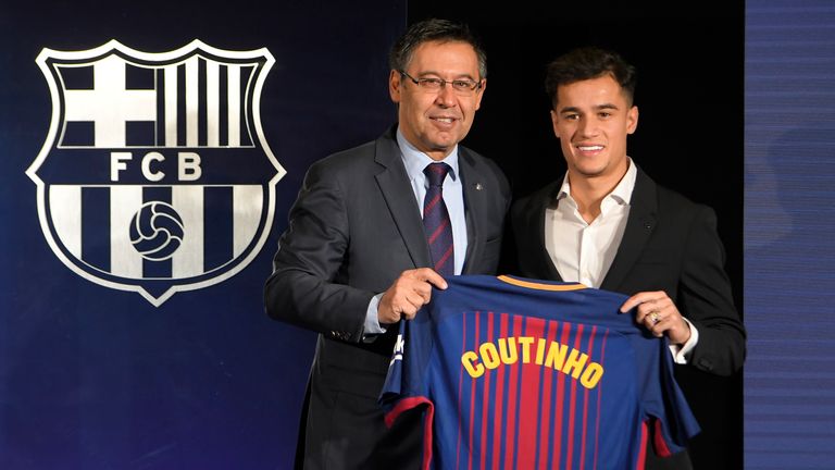 Philippe Coutinho poses with his new jersey beside Barcelona President Josep Maria Bartomeu during his official unveiling