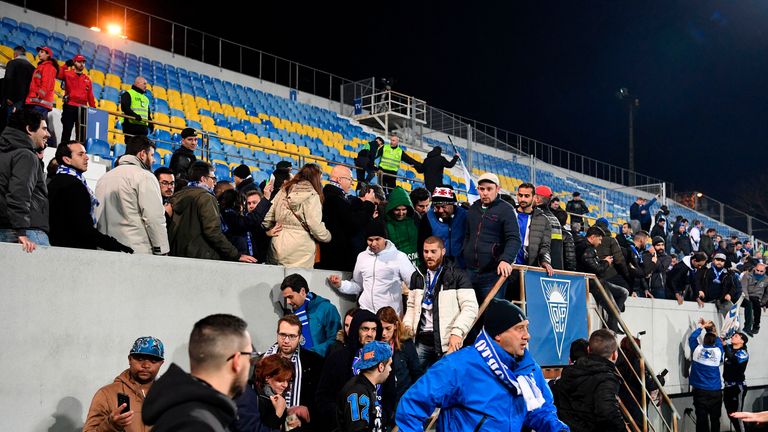 Spectators evacuate the stands following police and security personnel instructions during the Portuguese league football match between GD Estoril Praia an