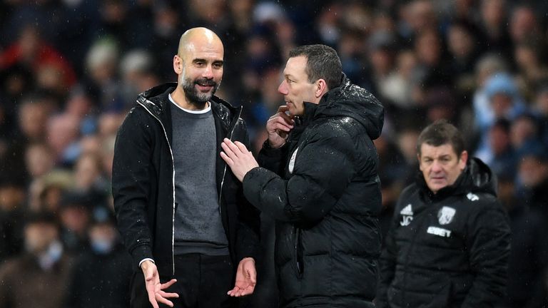 MANCHESTER, ENGLAND - JANUARY 31:  Josep Guardiola, Manager of Manchester City speaks with Fourth Official Kevin Friend during the Premier League match bet