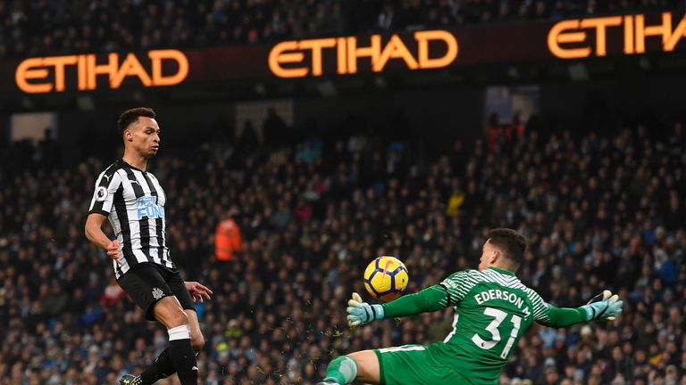 Jacob Murphy chips the ball over Ederson to pull a goal back for Newcastle United