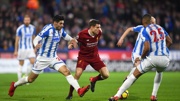 James Milner holds off Christopher Schindler during the Premier League match between Huddersfield Town and Liverpool