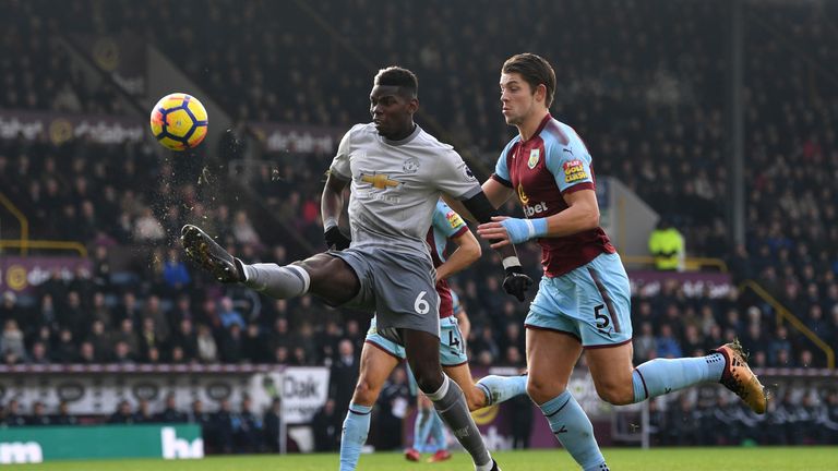 Paul Pogba controls the ball while under pressure from James Tarkowski
