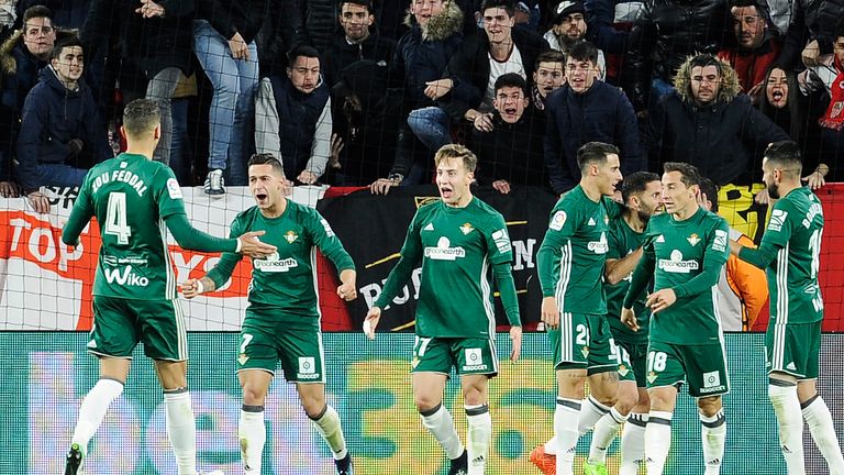 Real Betis' Spanish forward Sergio Leon (2ndL) celebrates with teammates after scoring a goal during the Spanish league football match between Sevilla and 