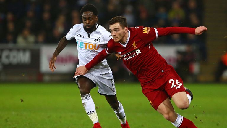 Liverpool's Scottish defender Andrew Robertson (R) vies with Swansea City's English midfielder Nathan Dyer during the English Premier League football match