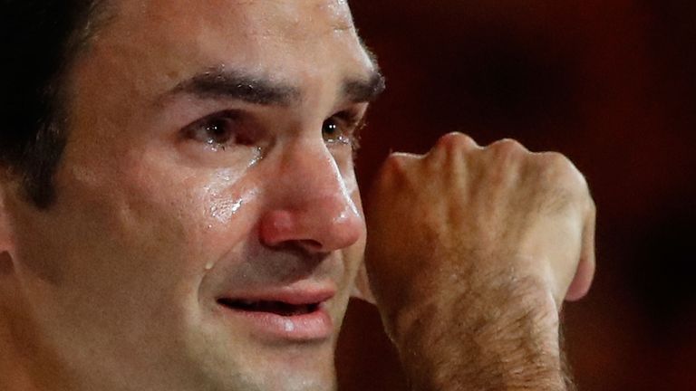 An emotioinal Roger Federer of Switzerland wipes away a tear as he poses with the Norman Brookes Challenge Cup