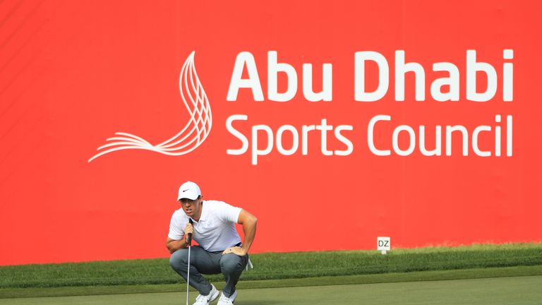 ABU DHABI, UNITED ARAB EMIRATES - JANUARY 18:  Rory McIlroy of Northern Ireland lines up a putt on the 18th green during round one of the Abu Dhabi HSBC Go