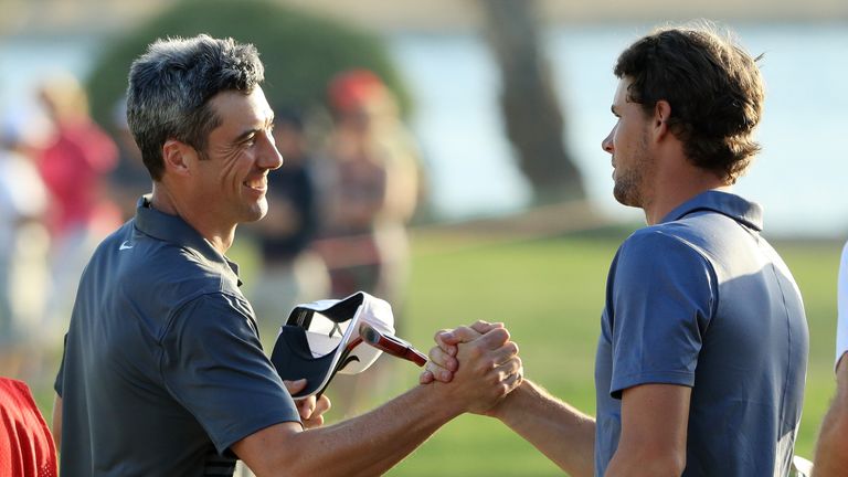 Ross Fisher of England and Thomas Pieters of Belgium shake hands on the 18th green at the Abu Dhabi Championship