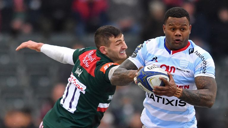 Leicester Tigers' Jonny May (L) attempts a tackle on Racing 92's Virimi Vakatawa during the European Champions Cup clash