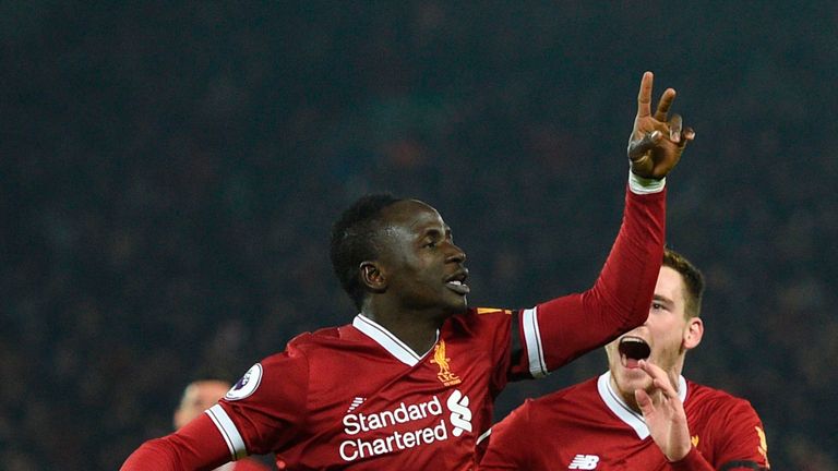 Liverpool's Senegalese midfielder Sadio Mane (L) celebrates scoring their third goal to extend their lead 3-1 with Liverpool's Scottish defender Andrew Rob