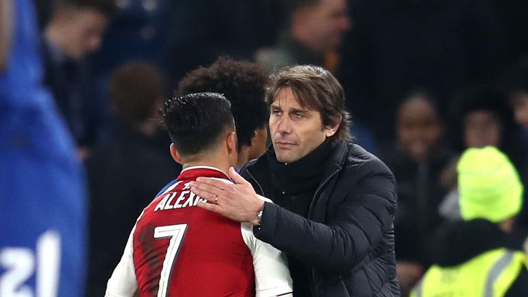 LONDON, ENGLAND - JANUARY 10:  Alexis Sanchez of Arsenal speaks with Antonio Conte, Manager of Chelsea during the Carabao Cup Semi-Final First Leg match be
