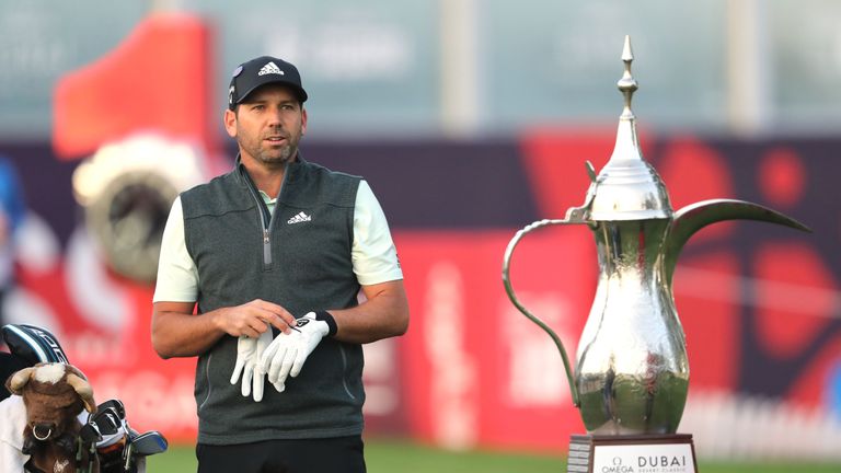 DUBAI, UNITED ARAB EMIRATES - JANUARY 24:  Sergio Garcia of Spain the defending champion waits to play his tee shot from beside the trophy on the first tee