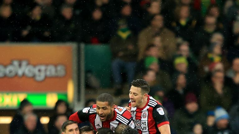 NORWICH, ENGLAND - JANUARY 20:  James Wilson of Sheffield United is mobbed as he celebrates scoring the opening goal during the Sky Bet Championship match 