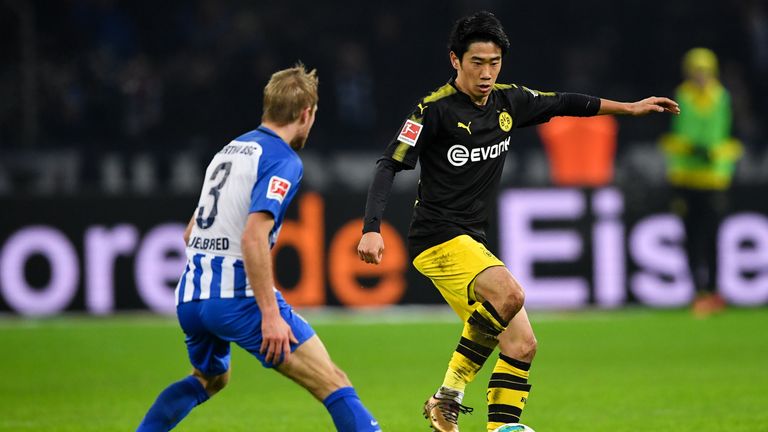 BERLIN, GERMANY - JANUARY 19: Shinji Kagawa #23 of Borussia Dortmund and Per Ciljan Skjelbreid #3 of Hertha Berlin battle for the ball during the Bundeslig